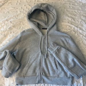 grey cropped brandy melville zip up hoodie, fits size xs, no signs of wear.